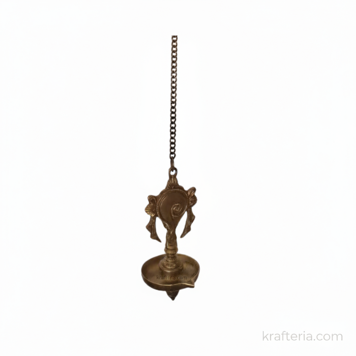 Antique brass diya wall hanging with Shankh Chakra design, spiritual home decor oil lamp.