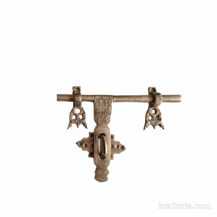 Antique brass door latch, a traditional trishul-shaped decorative door bolt.
