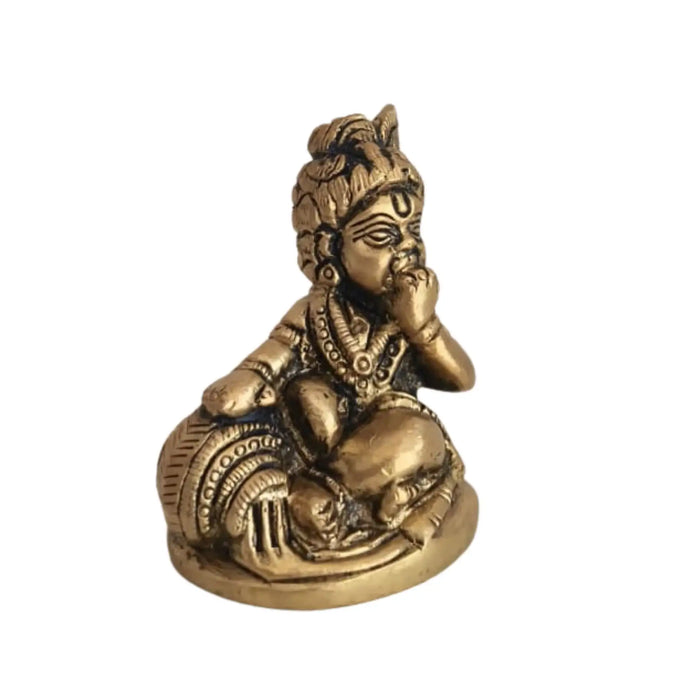 Brass Bal Krishna idol, a charming baby Krishna holding a butter ball, crafted from brass.
