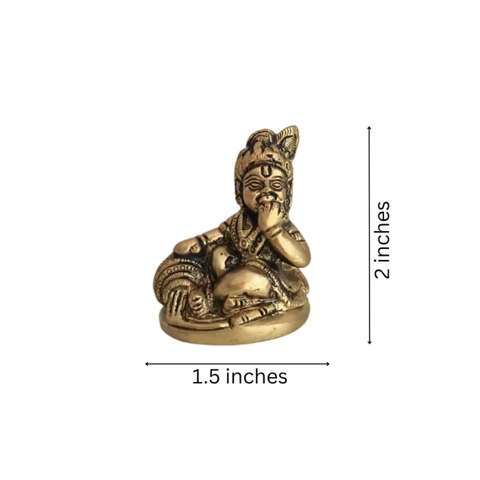 Brass Bal Krishna Idol holding a butter ball, crafted from brass.