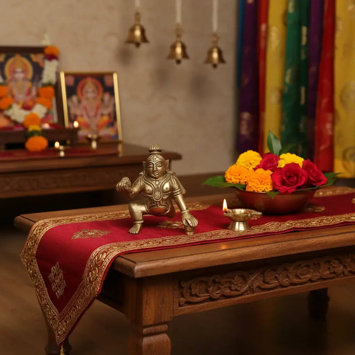 Brass Bal Krishna idol holding a butter ball, made from brass ware.