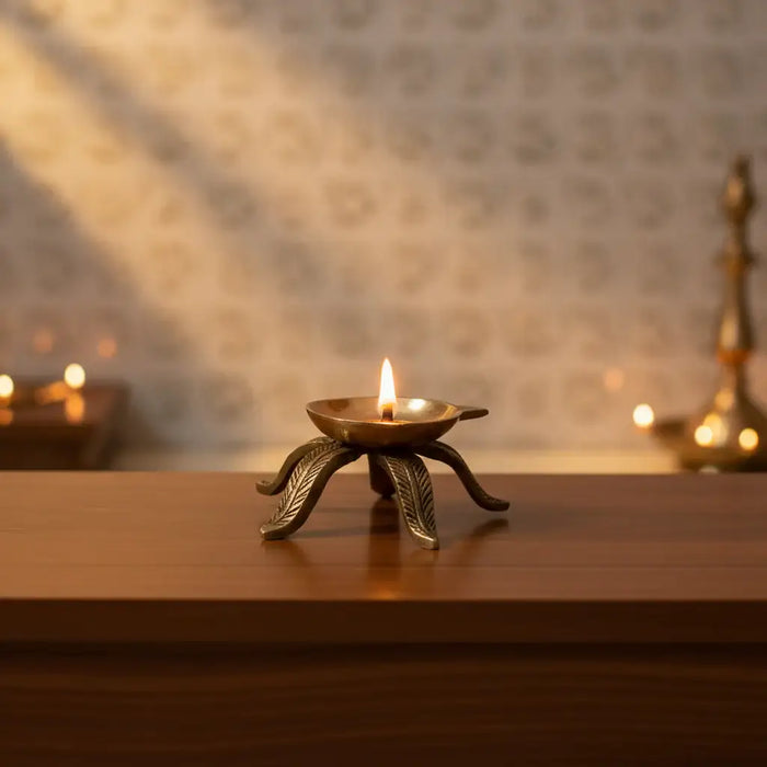Elegant Brass Diya Stand Leaf-Foot with intricate leaf-shaped feet.