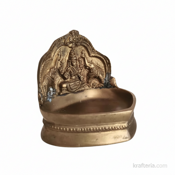 Gajalakshmi brass diya featuring Goddess Lakshmi with elephants, an ornate oil lamp.
