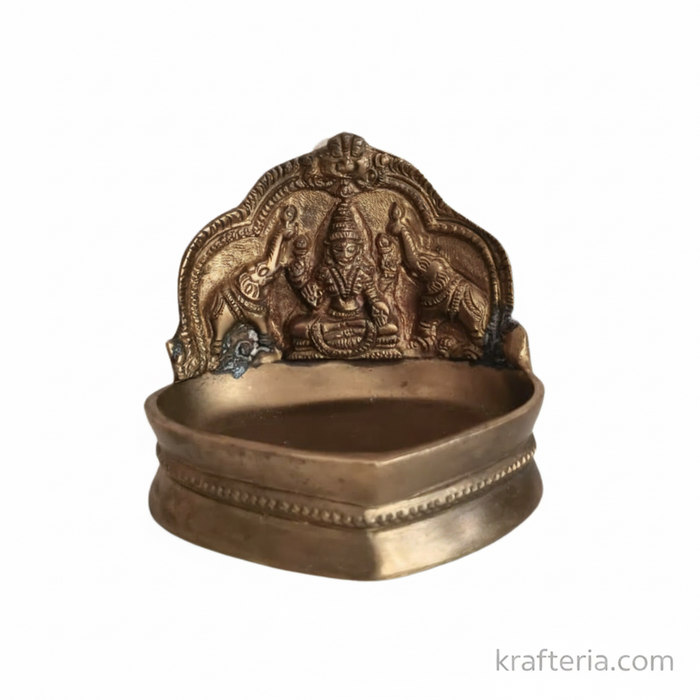 Gajalakshmi brass diya with Goddess Lakshmi and elephants, an ornate oil lamp.