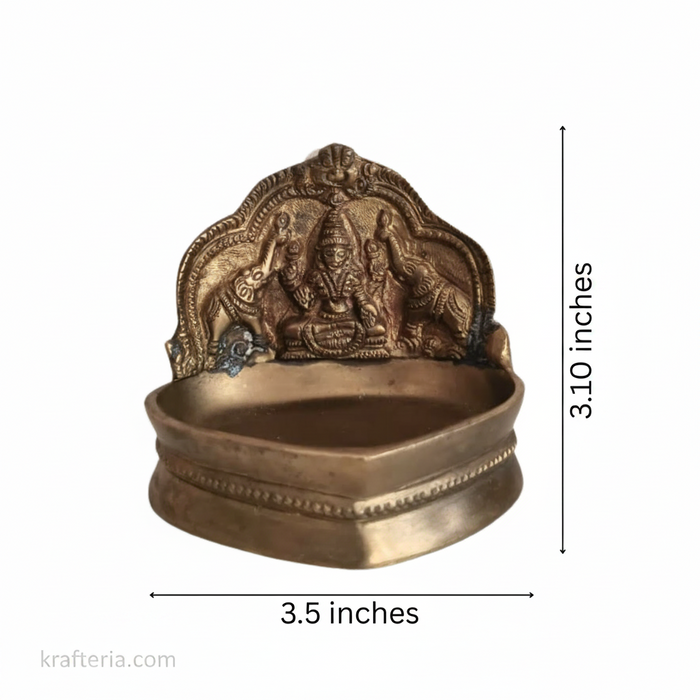 Brass Gajalakshmi brass diya, featuring Goddess Lakshmi flanked by elephants, for oil lamp lighting.