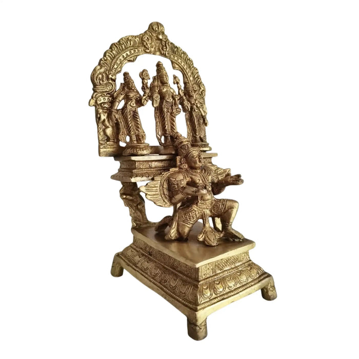 Brass Garuda Vishnu idol with Sridevi & Bhudevi, traditional Hindu temple sculpture.