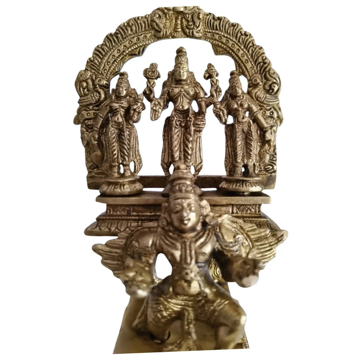 Brass Garuda Vishnu idol with Sridevi and Bhudevi, traditional Hindu temple sculpture.