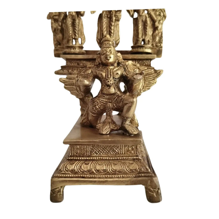 Brass Garuda Vishnu idol with Sridevi & Bhudevi, traditional Hindu temple sculpture.