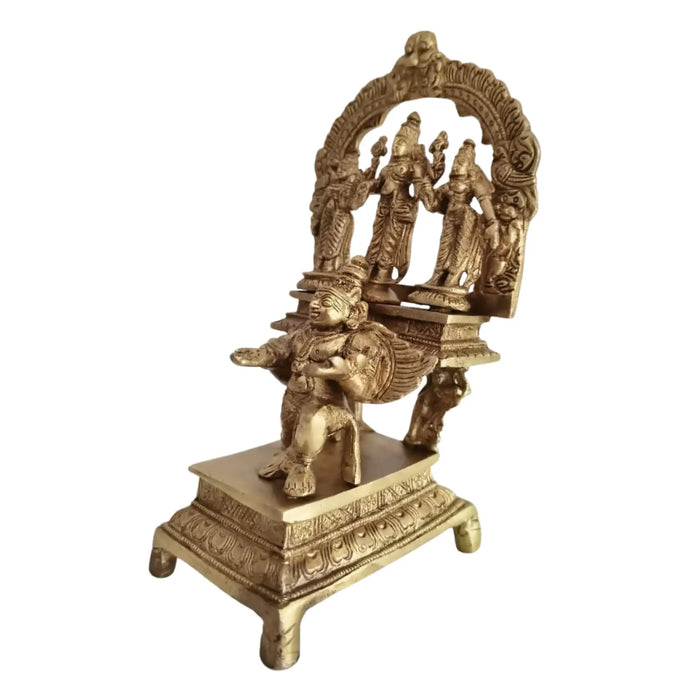 Brass Garuda Vishnu idol with Sridevi & Bhudevi, traditional Hindu temple sculpture.