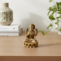 Brass Goddess Lakshmi Idol seated on lotus, four-armed deity made of brass ware.