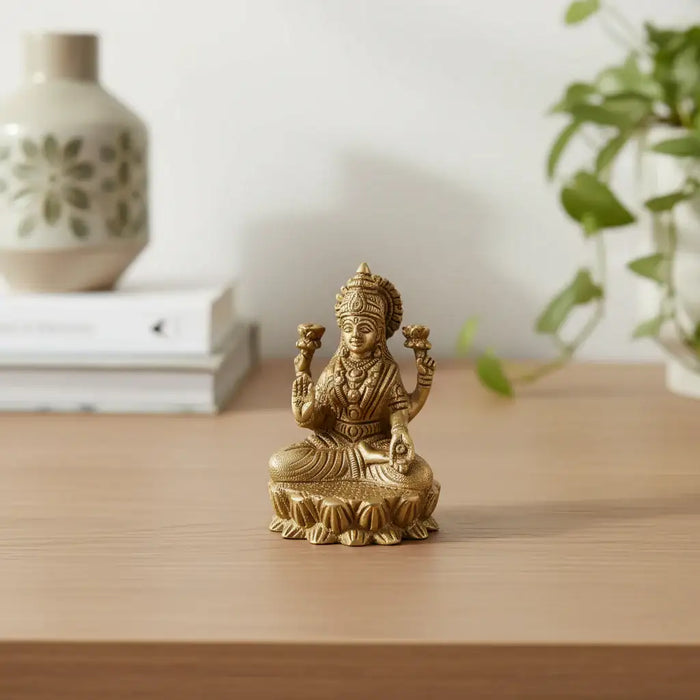 Brass Goddess Lakshmi Idol seated on lotus, four-armed deity made of brass ware.