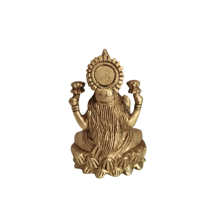 Brass Goddess Lakshmi Idol seated on a lotus, four-armed deity made of brass.