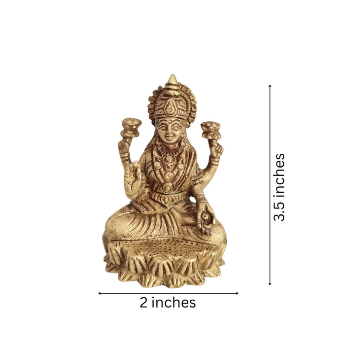 Brass Goddess Lakshmi Idol, four-armed, seated on a lotus.