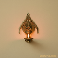 Brass Lakshmi diya wall hanging with ornate arch, traditional oil lamp.