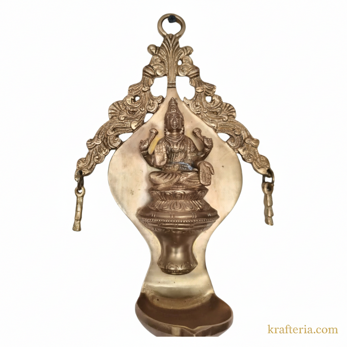 Brass Lakshmi diya wall hanging, ornate arch oil lamp.