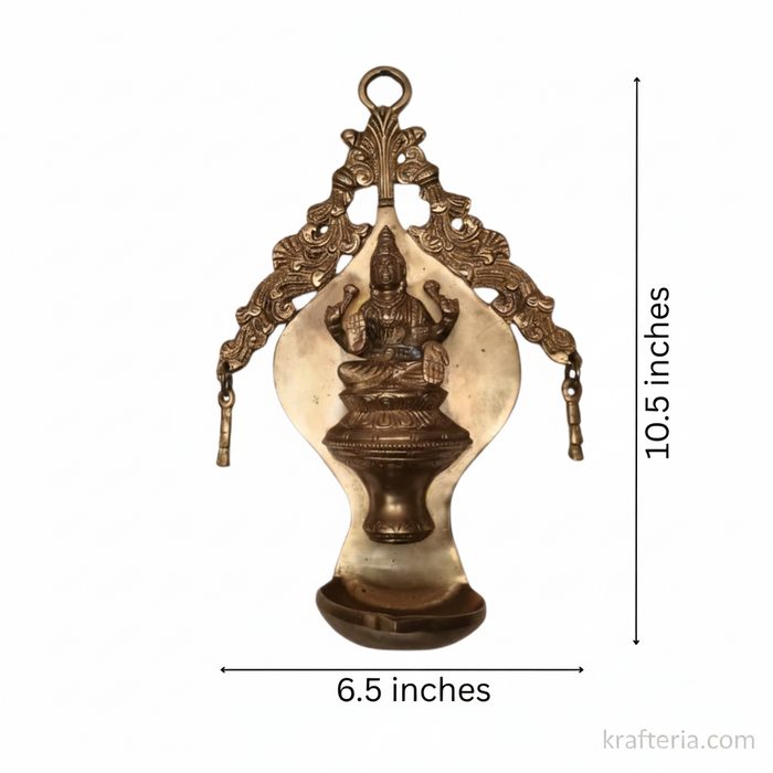 Ornate brass Lakshmi diya wall hanging, traditional oil lamp.