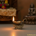 Ornate brass diya lamp with intricate swan handle, a traditional oil lamp for rituals.