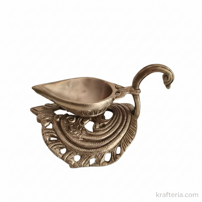 Handcrafted brass diya lamp with ornate swan handle, a traditional oil lamp for rituals.