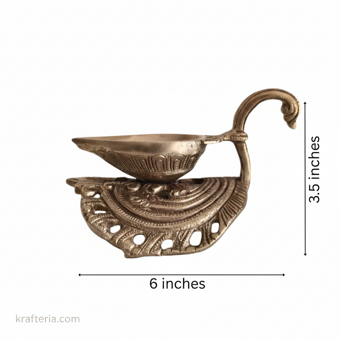 Intricate brass diya lamp with ornate swan handle for religious rituals.