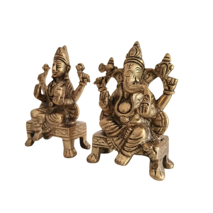 Brass Lakshmi and Ganesha idols, detailed craftsmanship.