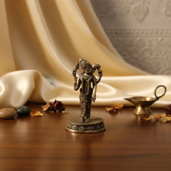 Brass statue of a deity on a white background