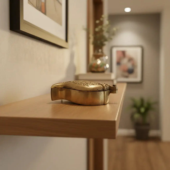 A brass mango shaped decorative box for storage, engraved with paisley patterns.