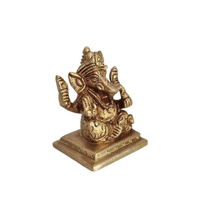 Miniature Lord Ganesha Idol in brass, four-armed, symbolizing success and wisdom.