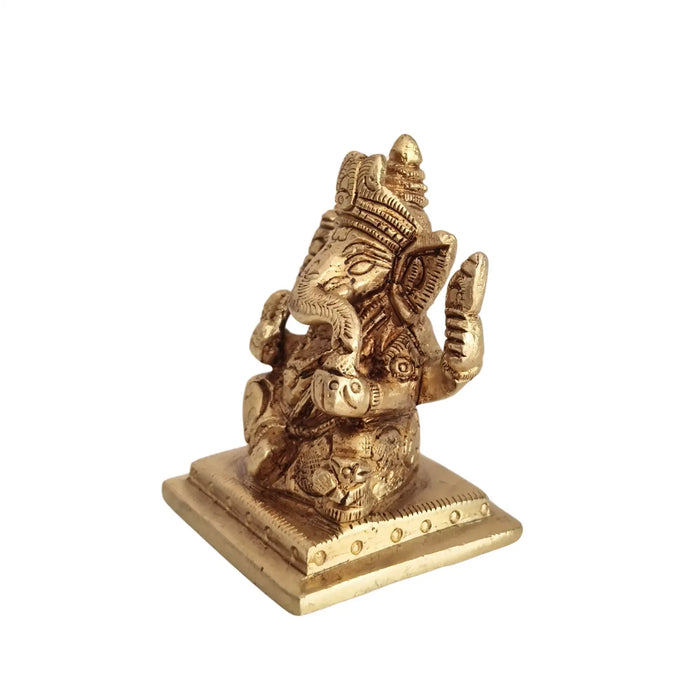 Miniature Lord Ganesha Idol in brass, four-armed, symbol of success and wisdom.