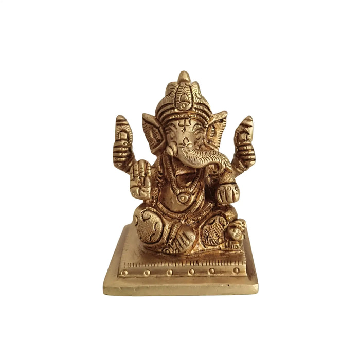 Miniature Lord Ganesha idol, four-armed brass deity of success and wisdom.