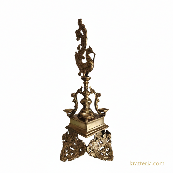 Elegant brass peacock diya with four wicks, a stunning decorative oil lamp.