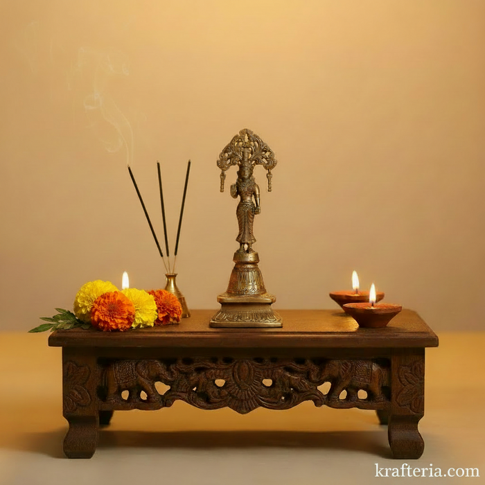 Ornate brass Radha goddess idol with a decorative prabhavali, a traditional religious statue.