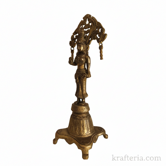 A traditional brass Radha goddess idol with a decorative prabhavali.