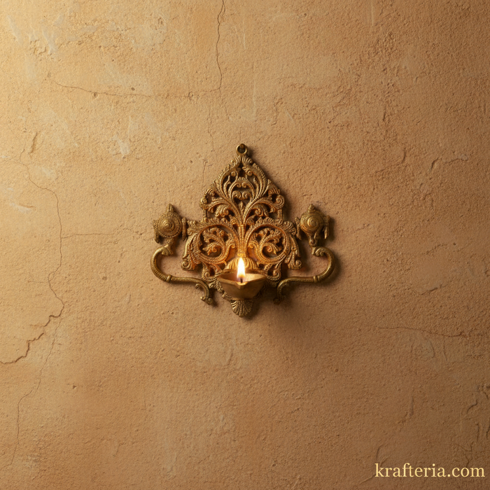 Intricate brass shankh chakra diya with filigree detailing, a traditional decorative lamp.