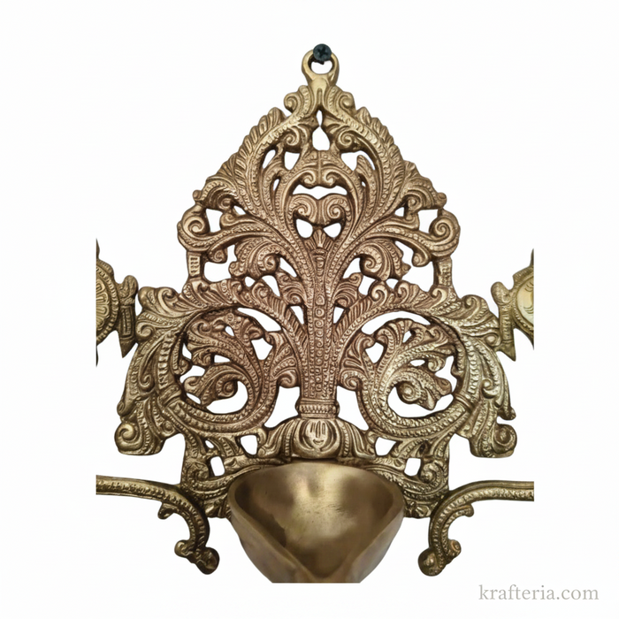 Brass shankh chakra diya with intricate filigree detailing, a traditional decorative lamp.