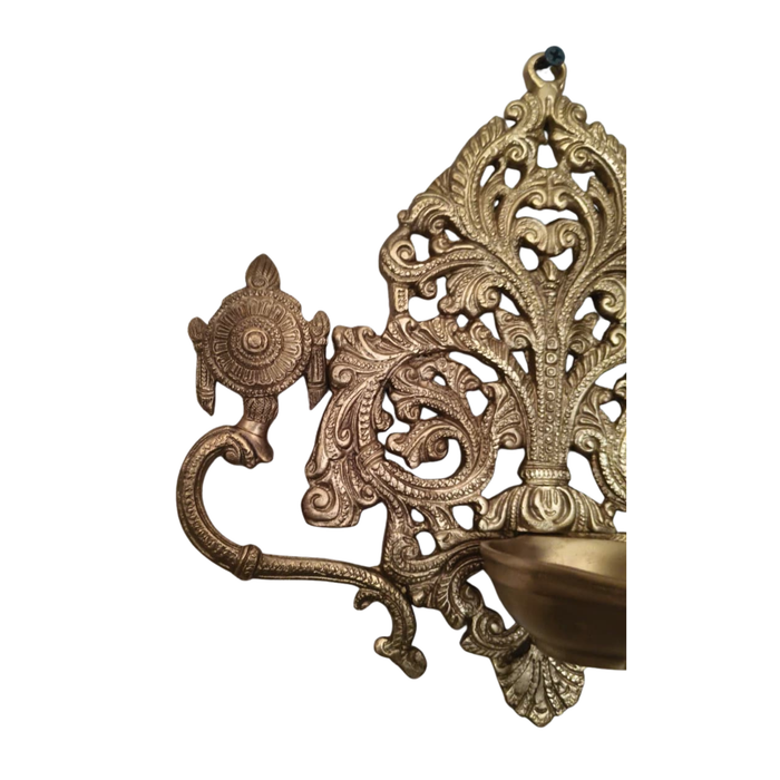 Brass shankh chakra diya, ornate traditional lamp with intricate filigree work.