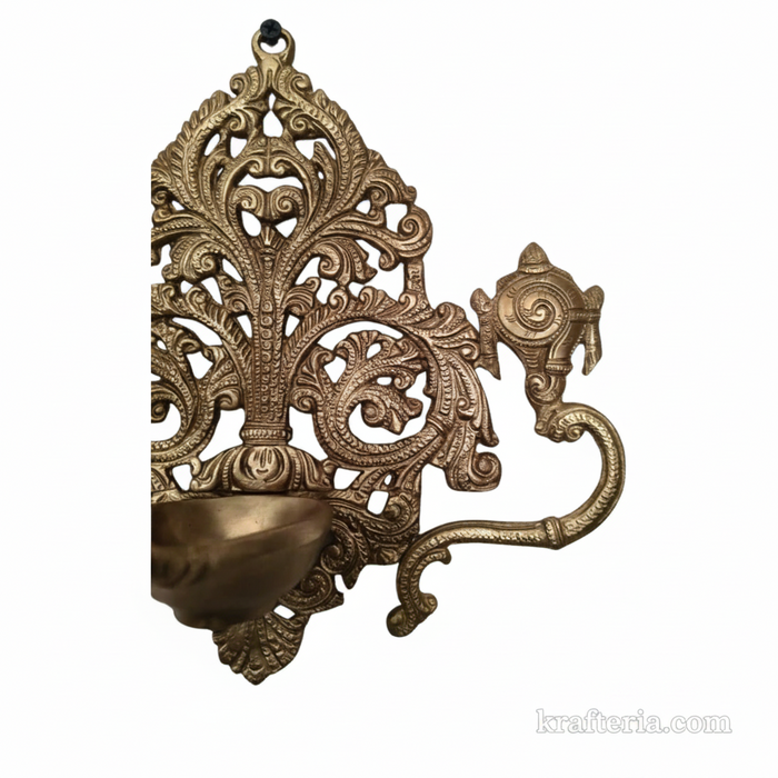 Decorative brass shankh chakra diya with intricate filigree work.