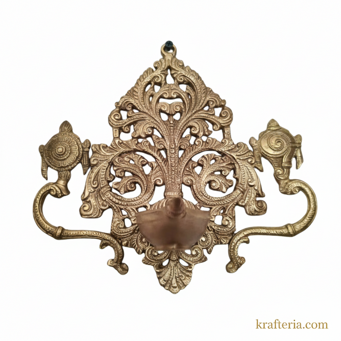 Decorative brass shankh chakra diya with intricate filigree detail.