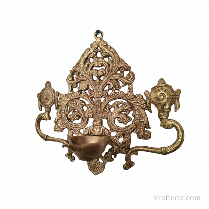 Brass shankh chakra diya, a decorative traditional lamp with intricate filigree work.