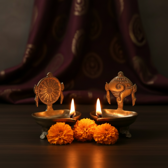 Brass shankh chakra diya set with intricate detailing, a pair of spiritual oil lamps.