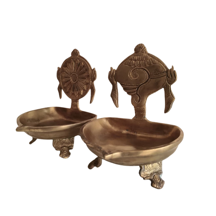 Brass shankh chakra diya set for spiritual oil lamps and decor.