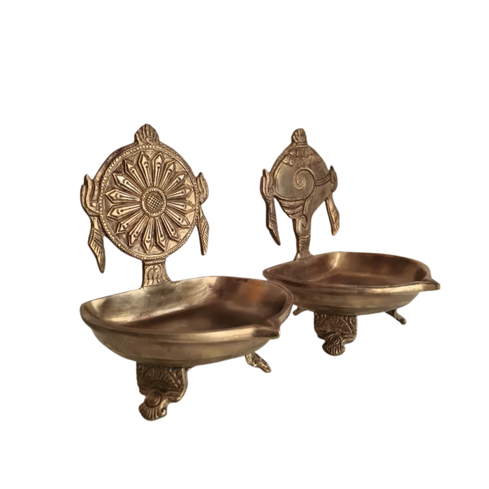 Brass shankh chakra diya set, spiritual oil lamps for home decor.