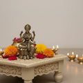 Classic Four-Armed Brass Lakshmi Idol Seated on Lotus - Symbol of Prosperity   Brass Ware