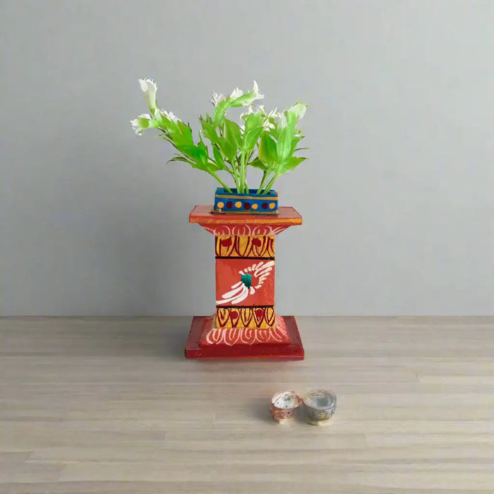 Handcrafted Kondapalli Tulasi plant stand in vibrant Kondapalli lacquerware, a decorative devotional item.