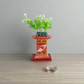 Handcrafted Kondapalli Tulasi plant stand in vibrant Kondapalli lacquerware, a decorative devotional item.