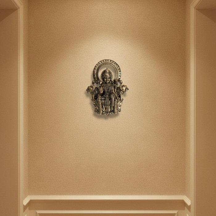 Brass Gajalakshmi wall hanging, detailed brass finish wall art depicting the goddess Lakshmi.