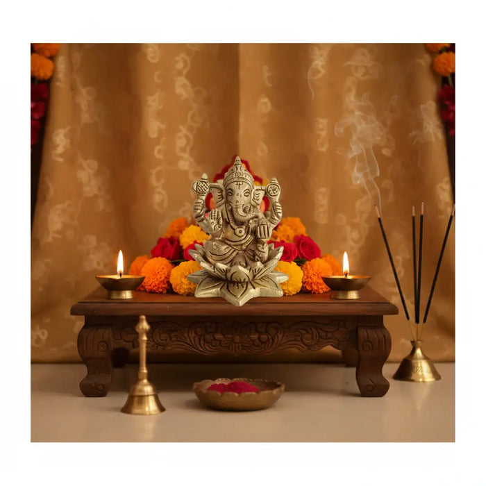 Golden brass Ganesha idol seated on a lotus, intricate brass ware.