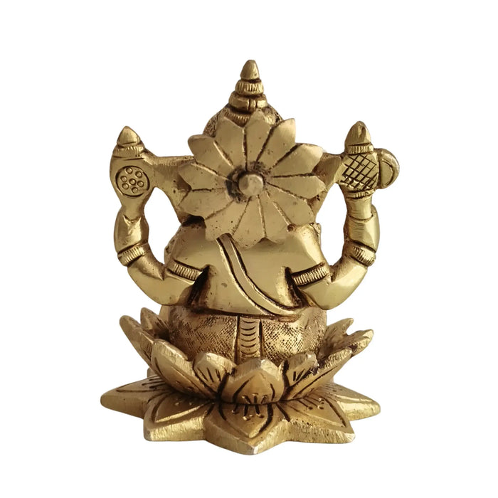 Golden brass Ganesha idol seated on a lotus, meticulously crafted brass ware.