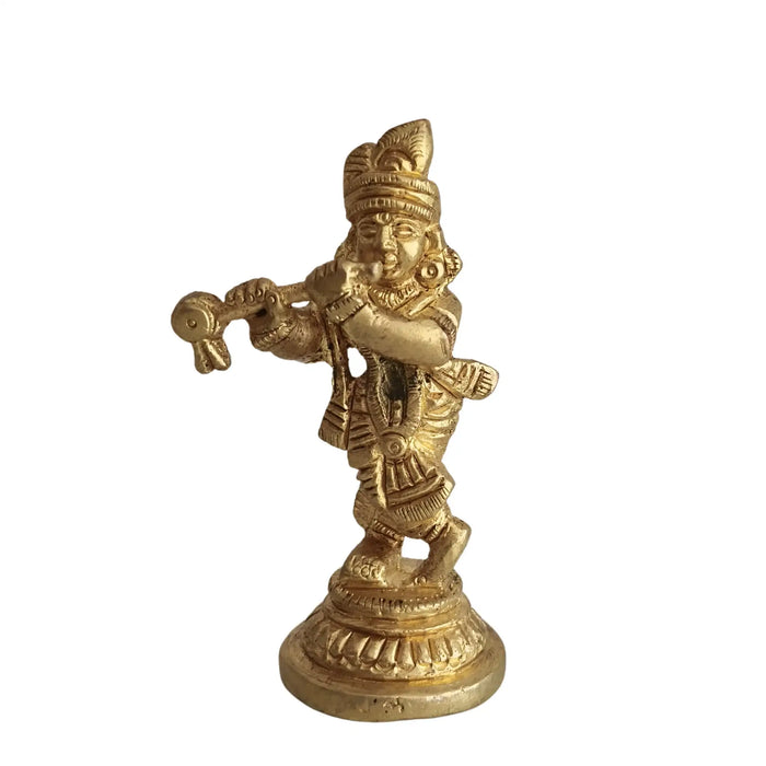 Golden brass Lord Krishna idol playing flute.