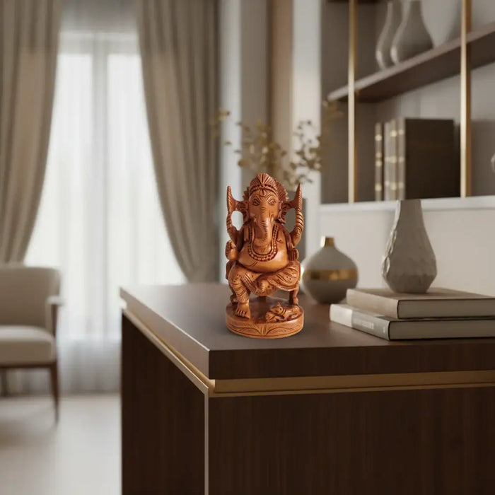 A detailed hand-carved wooden statue of Lord Ganesha, seated on a throne with intricate carvings, and his mouse vehicle at his feet.