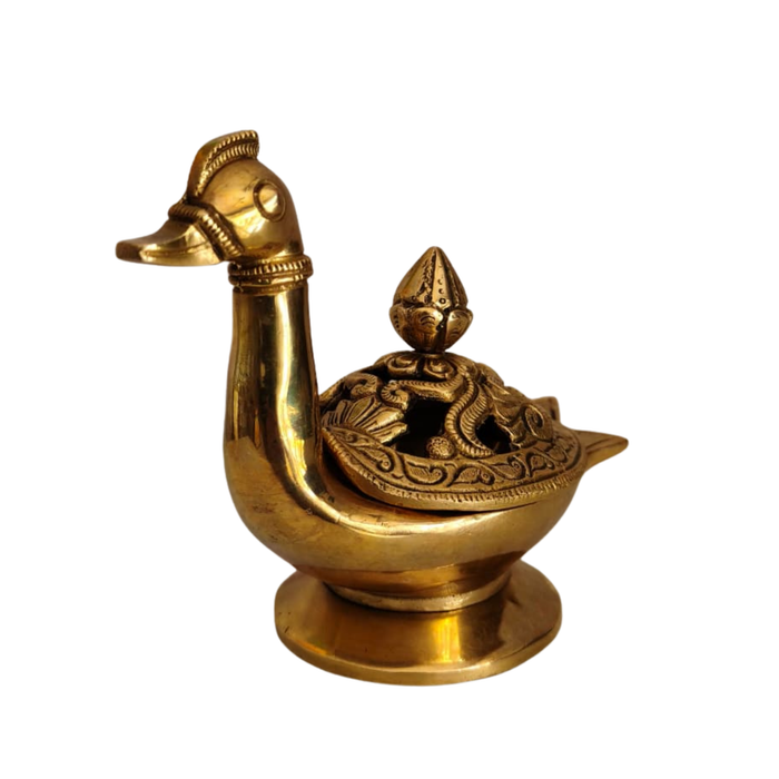 Handcrafted brass peacock artifact with engraved lid, a decorative brass art piece.